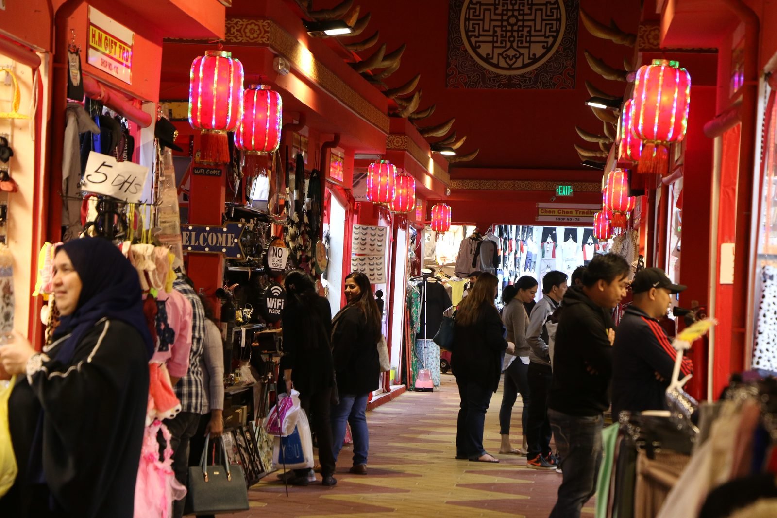 Busy shopping street inside Global Village Dubai in the evening