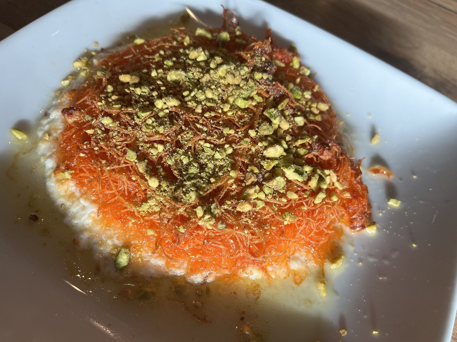Freshly prepared knafeh with cheese and crushed pistachio, a classic Middle Eastern dessert served at Global Village Dubai