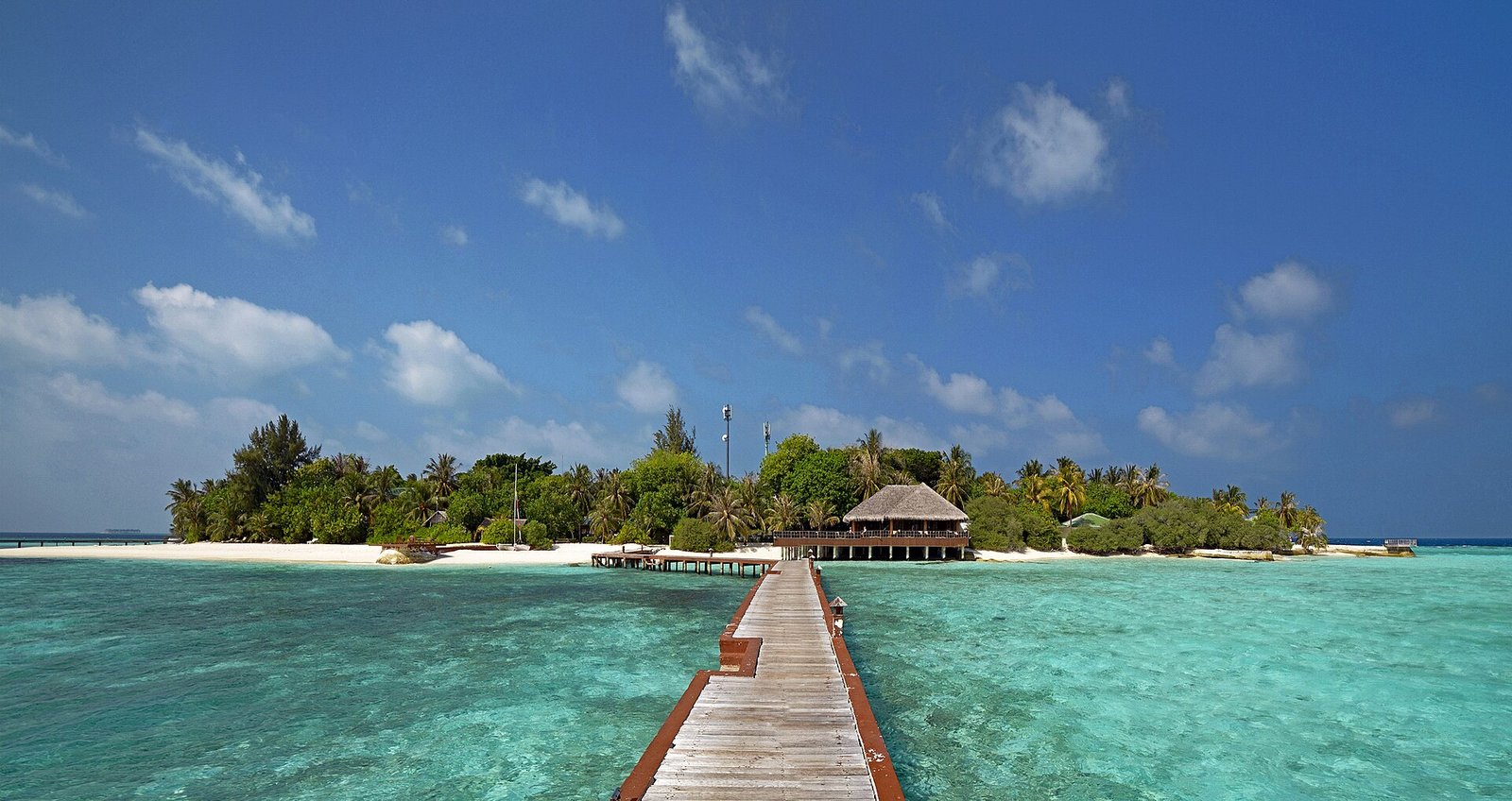 Aerial view of a Maldives island with turquoise lagoon, a visa-on-arrival destination for Indian passport holders