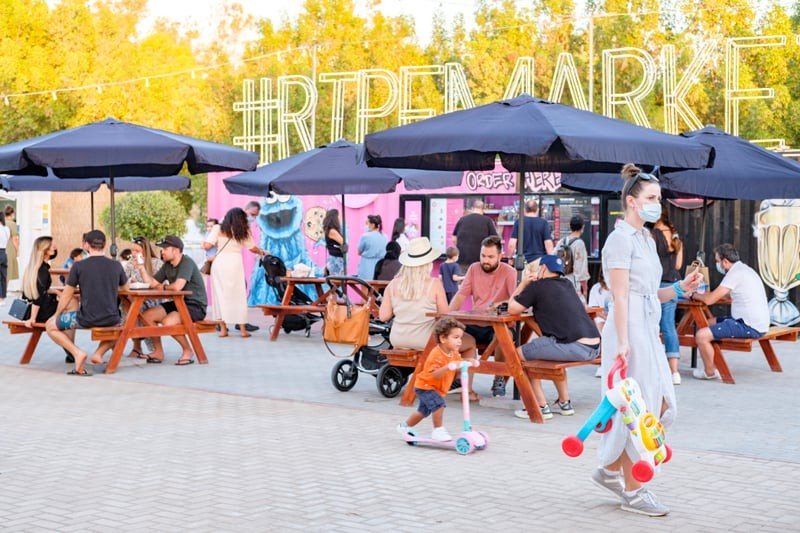 Visitors browsing colourful food stalls at Ripe Market Dubai in Academy Park