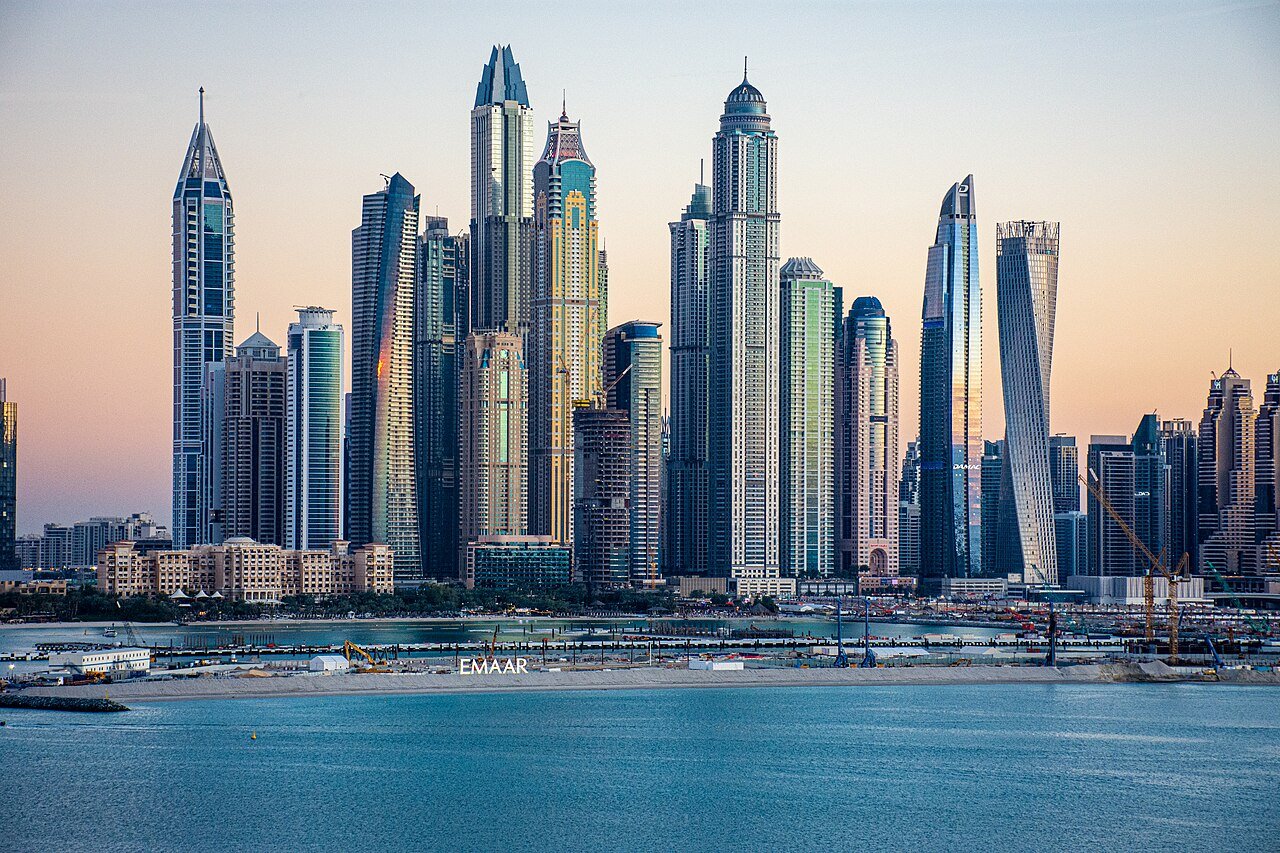 High-rise residential towers in Dubai Marina at sunset, where bed spaces and private rooms cost the most