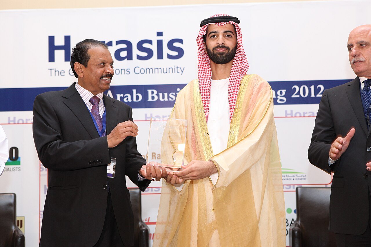 M.A. Yusuff Ali receiving an award on stage, recognising his business and philanthropic achievements