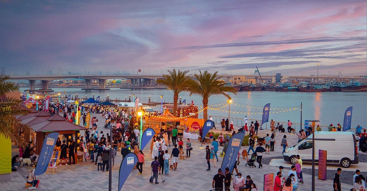 Stalls lit up at a Dubai night market after dark