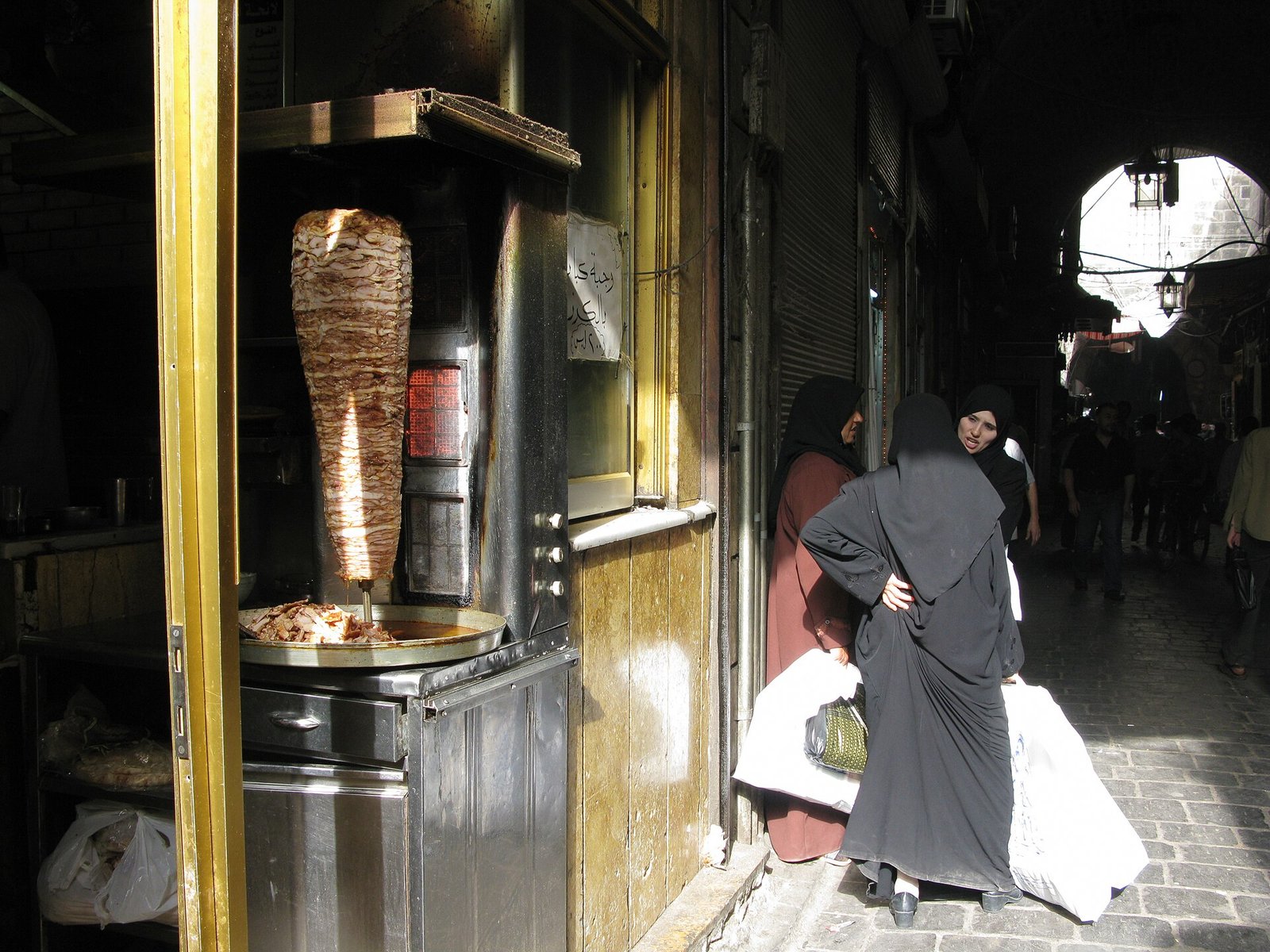 Shawarma kebab stand with meat roasting on a vertical spit